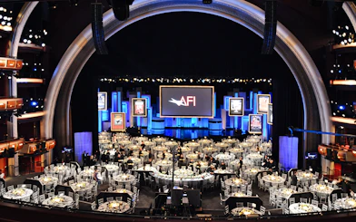 Dolby Theatre interior set up for an event with tables and stage.