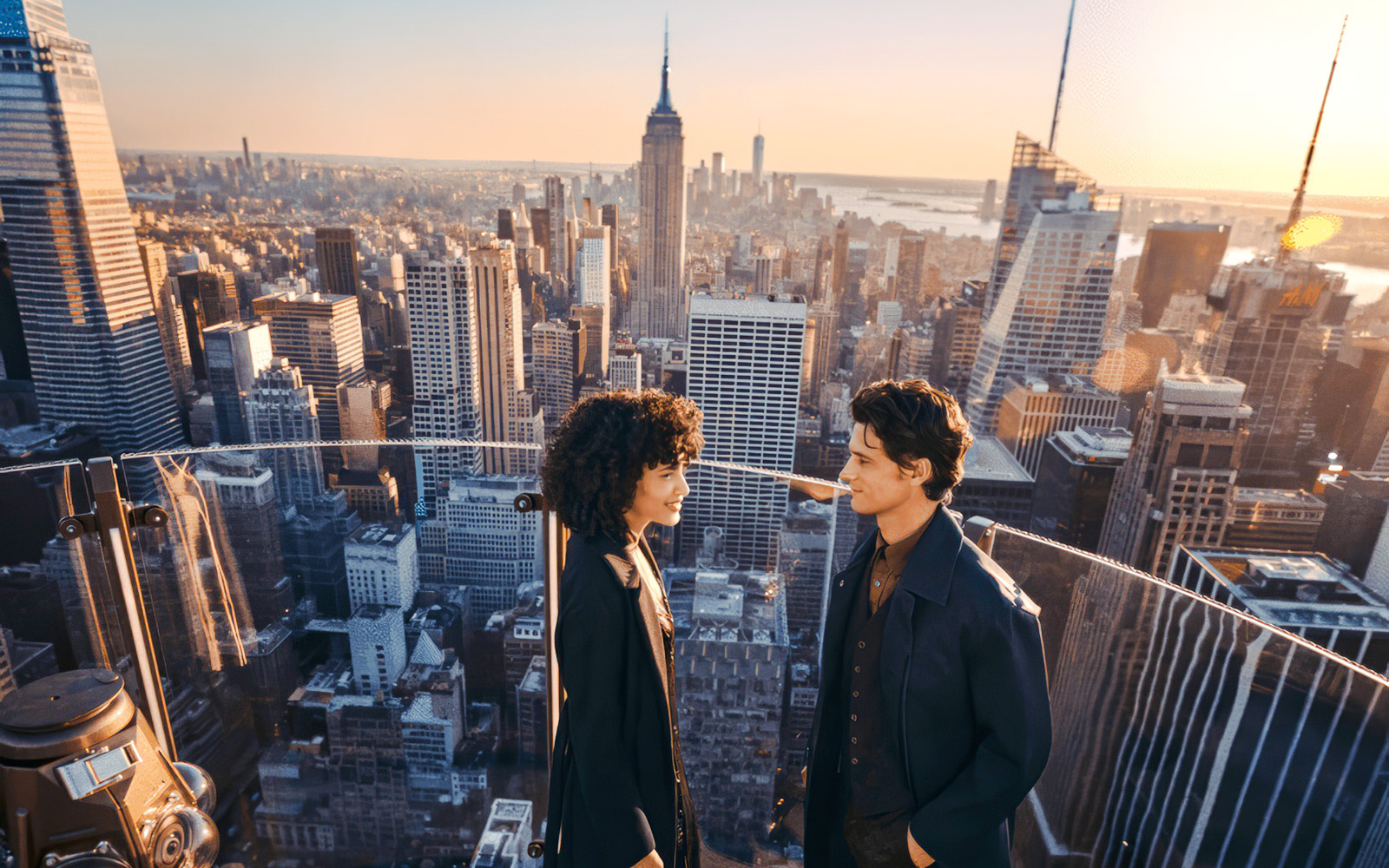 Couple enjoying the view from Top of the Rock, New York City skyline in background.