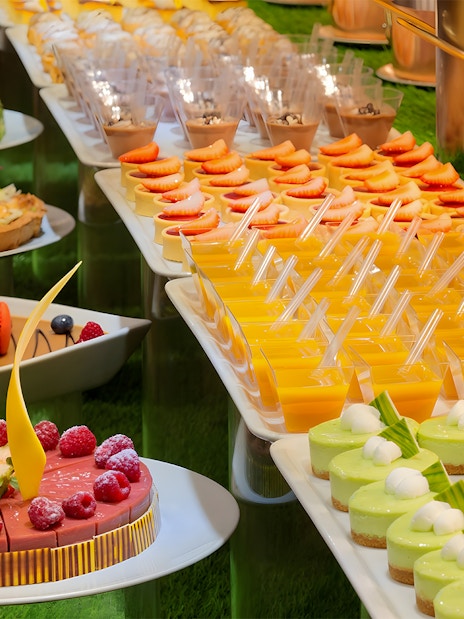 Dessert selection at Kaleidoscope buffet, Atlantis Dubai, featuring cakes and fruit tarts.