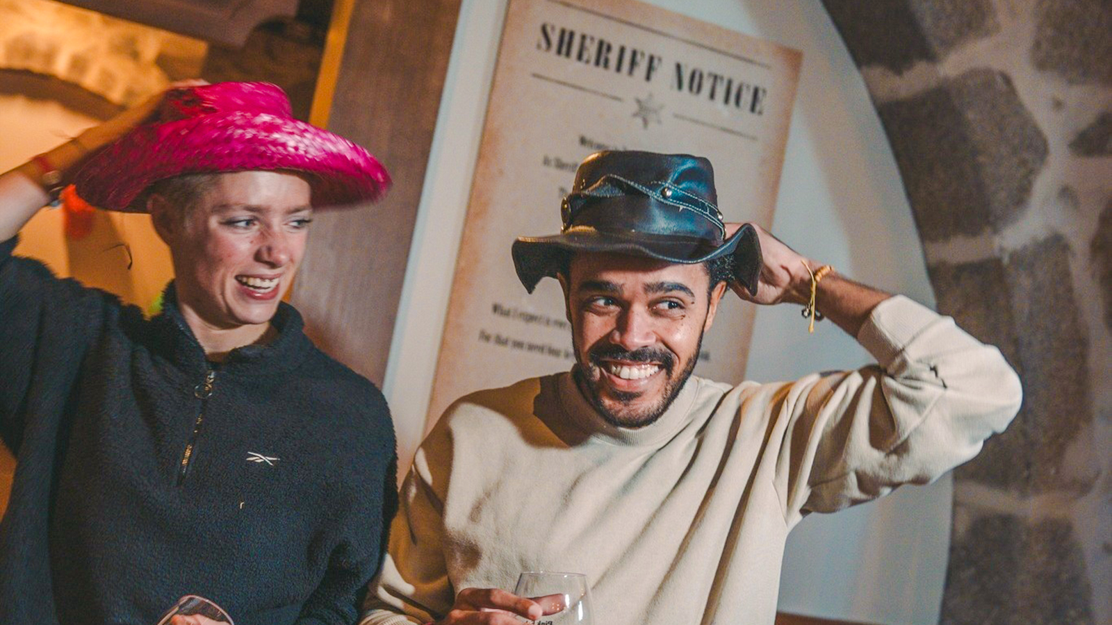 Guests enjoying a themed event at the Pink Palace with cowboy hats.