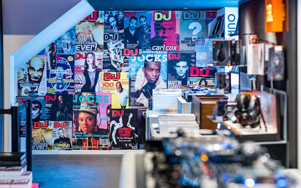 DJ magazine covers wall at Our House Museum of Electronic Dance Music.