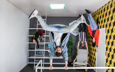 Visitors experiencing an upside-down room at the Museum of Illusions in Madrid.
