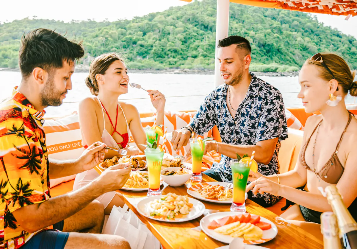 Group enjoying buffet lunch on a yacht during Pattaya 3-island cruise.