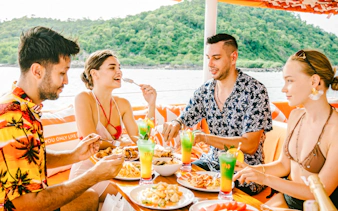 Group enjoying buffet lunch on a yacht during Pattaya 3-island cruise.