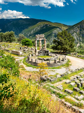 Temple of Athena Pronaia ruins with mountains in Delphi, Greece.