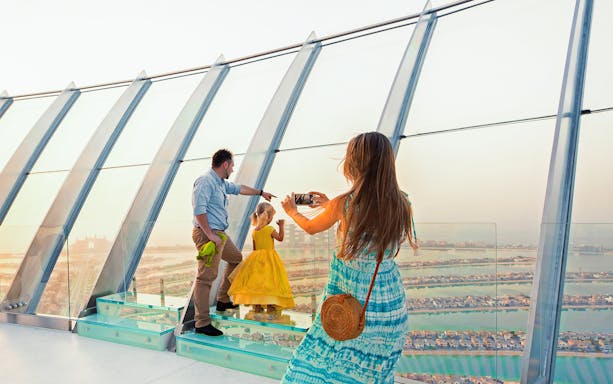 Family enjoying the view from The Palm's observation deck in Dubai.