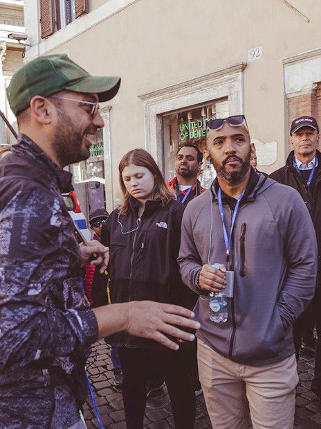 Tour group listening to a guide near Trevi Fountain, Rome.