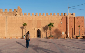 Person walking towards the ancient city wall of Taroudannt, Morocco.