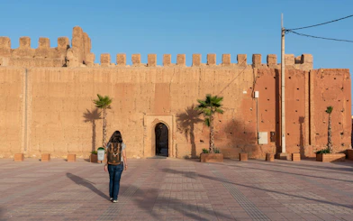 Person walking towards the ancient city wall of Taroudannt, Morocco.