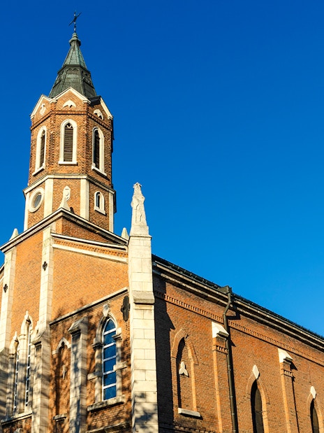 St. Paul's Church in Ruse with its brick facade and tall steeple against a clear blue sky.