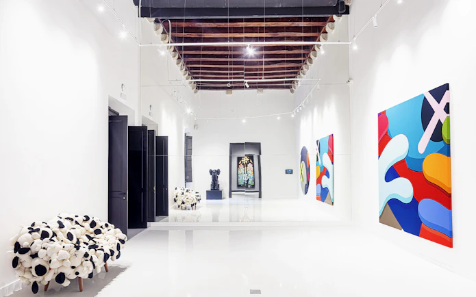 Contemporary art exhibits at Moco Museum in Barcelona hallway.