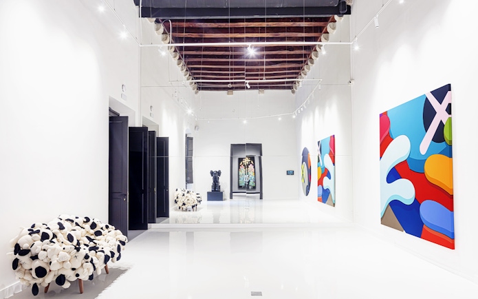 Contemporary art exhibits at Moco Museum in Barcelona hallway.