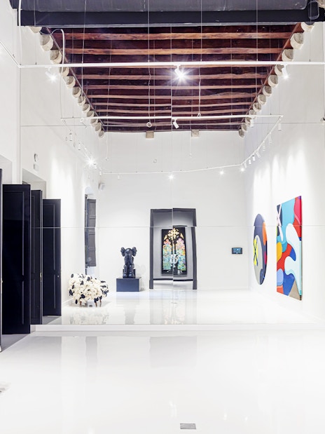 Contemporary art exhibits at Moco Museum in Barcelona hallway.