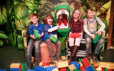 Kids with Lego dinosaur at Berlin Legoland Discovery Centre.