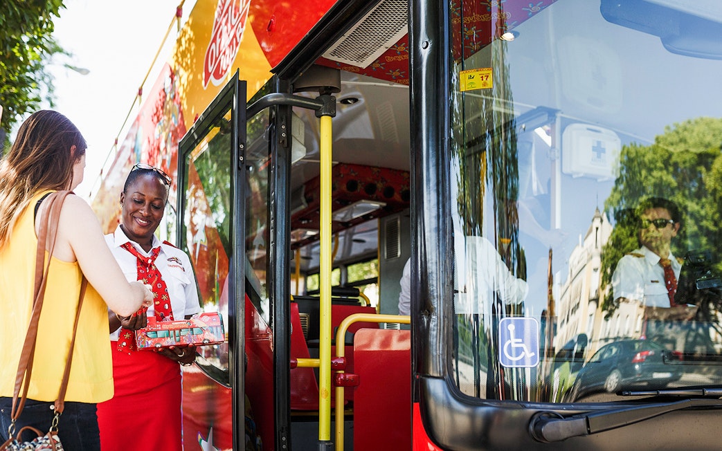 Bus staff assisting passenger during Messina to Taormina transfer.