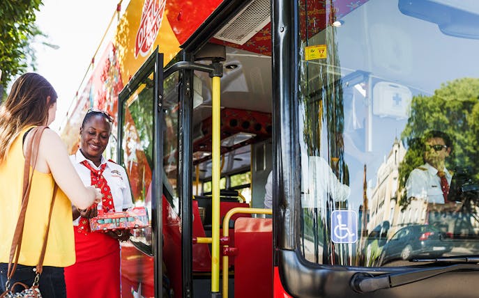 Bus staff assisting passenger during Messina to Taormina transfer.