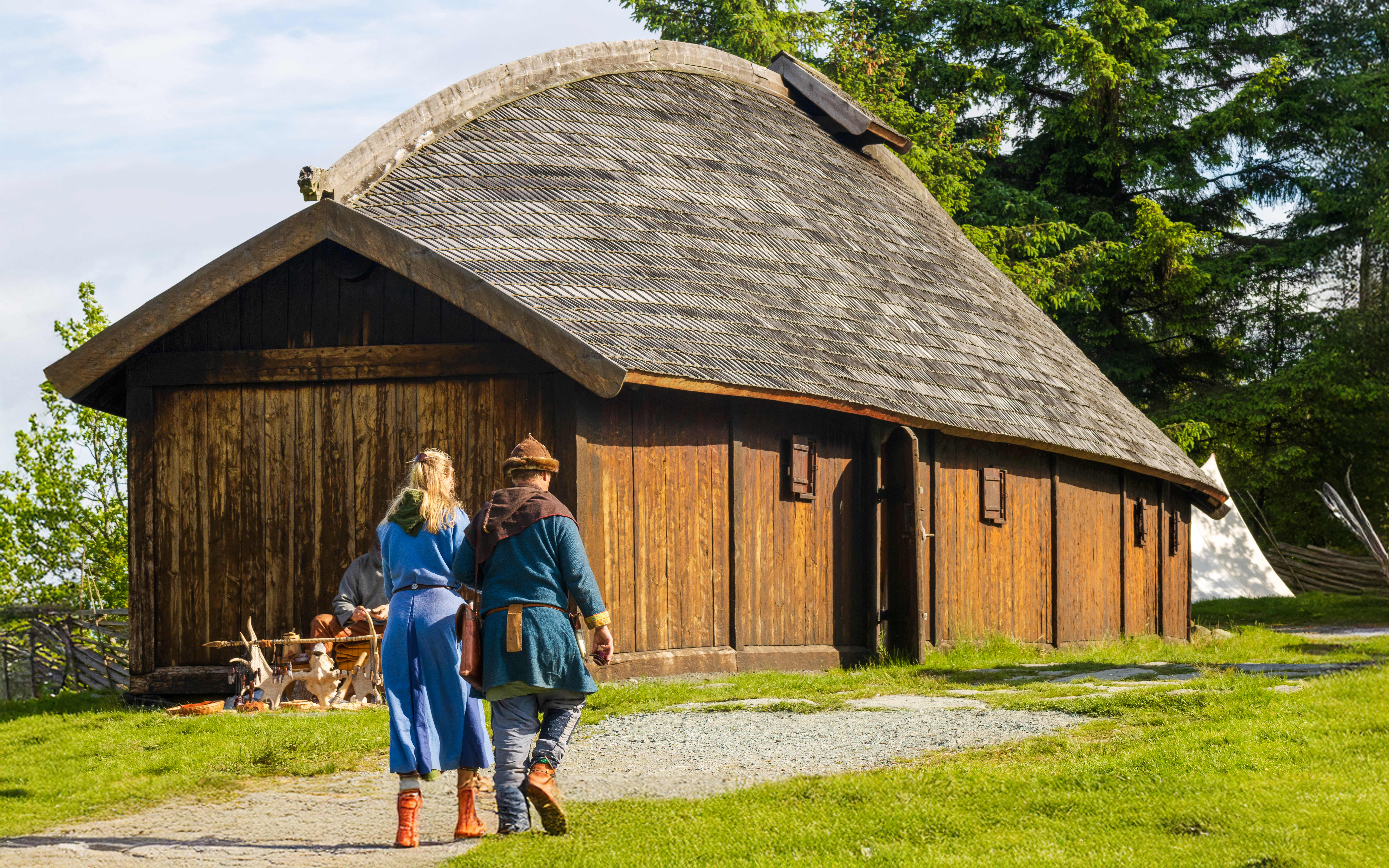 Visitors exploring Viking longhouse in Avaldsnes, Haugesund.