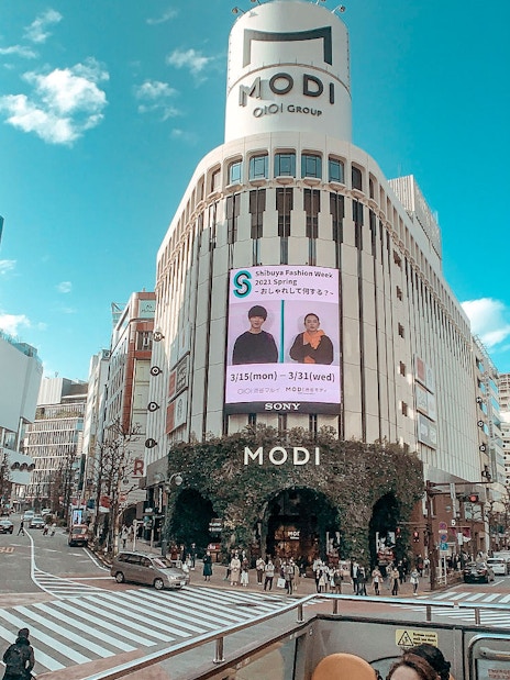 Tokyo street view from Sky Hop Bus with MODI building and Shibuya Fashion Week sign.