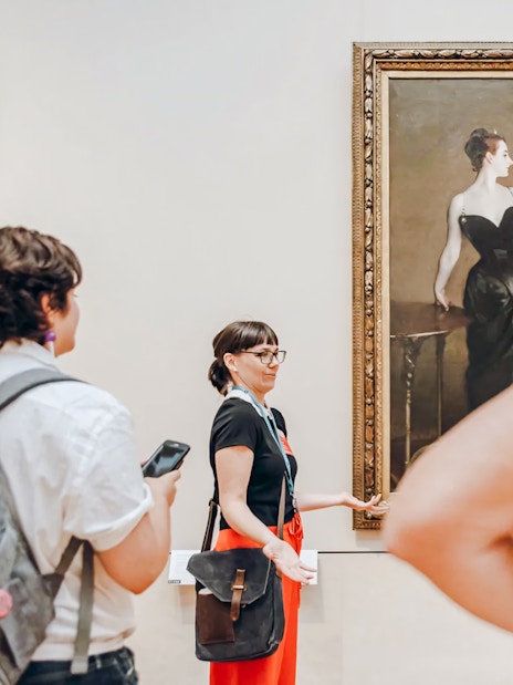 Visitors and tour guide at the Metropolitan Museum of Art viewing Portrait of Madame X by John Singer Sargent.