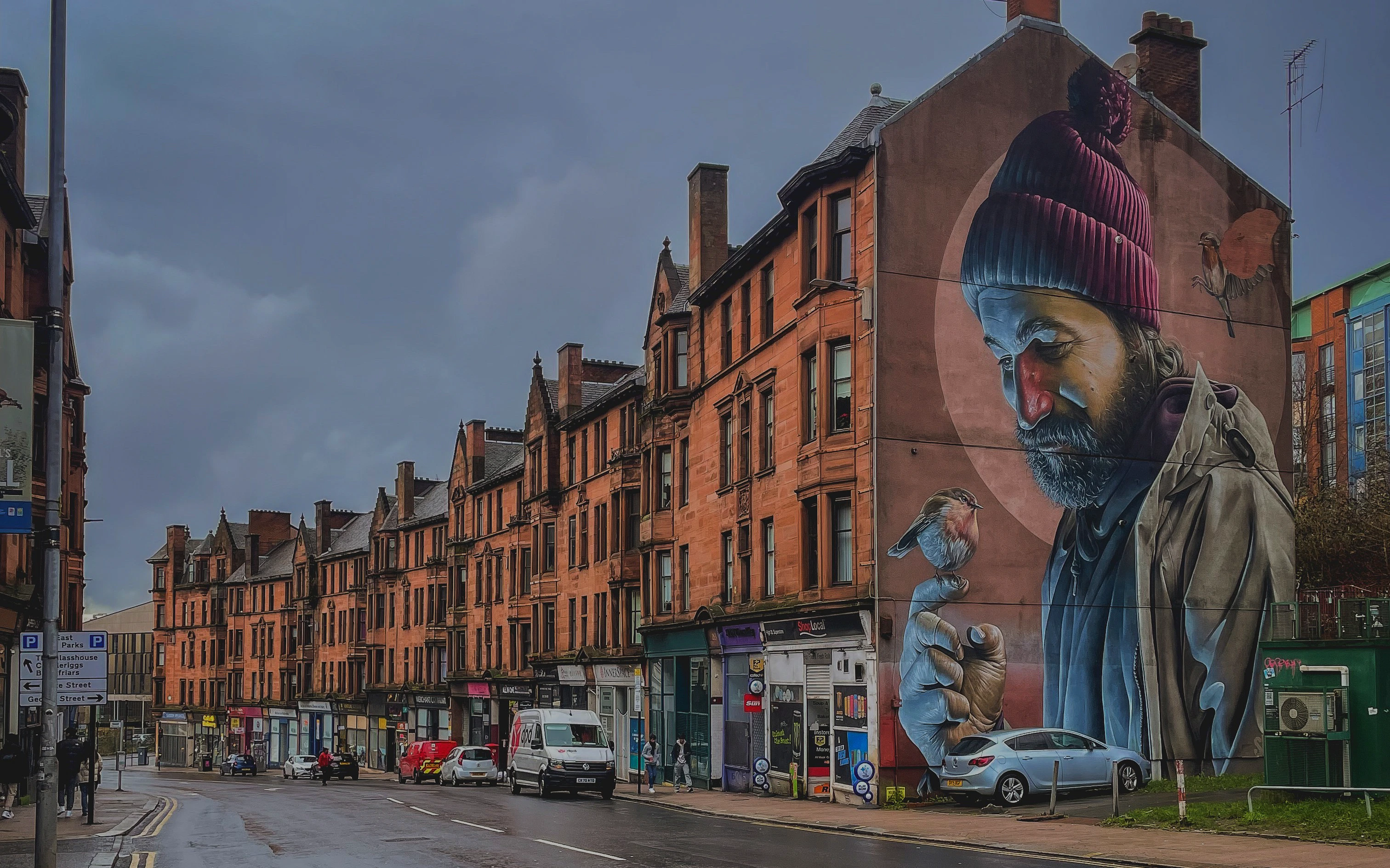 Street mural of a man with a bird on his finger, Glasgow mural trail.