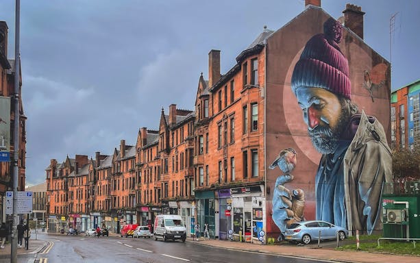Street mural of a man with a bird on his finger, Glasgow mural trail.