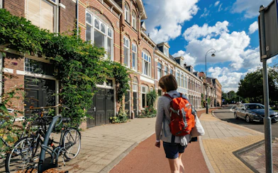 Person walking along a street with historic buildings in Haarlem.
