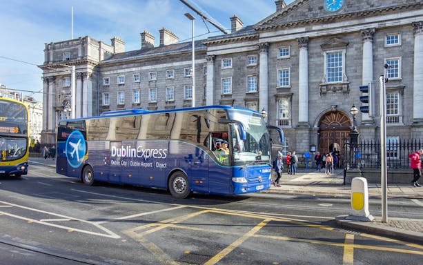 Dublin Express bus in front of historic building, offering one-way tickets from Belfast to Dublin Airport.