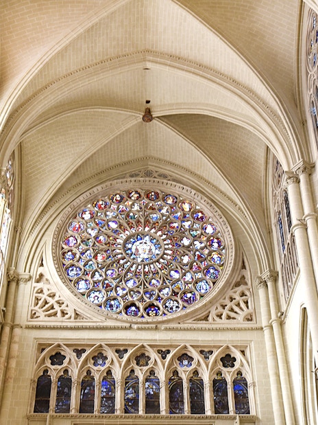 Stained glass rose window inside the Cathedral of Toledo during guided tour.