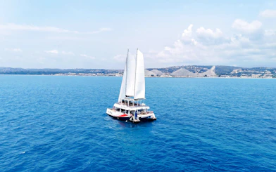 Catamaran sailing near Lérins Island with coastal view in Marina Bay of Angels.