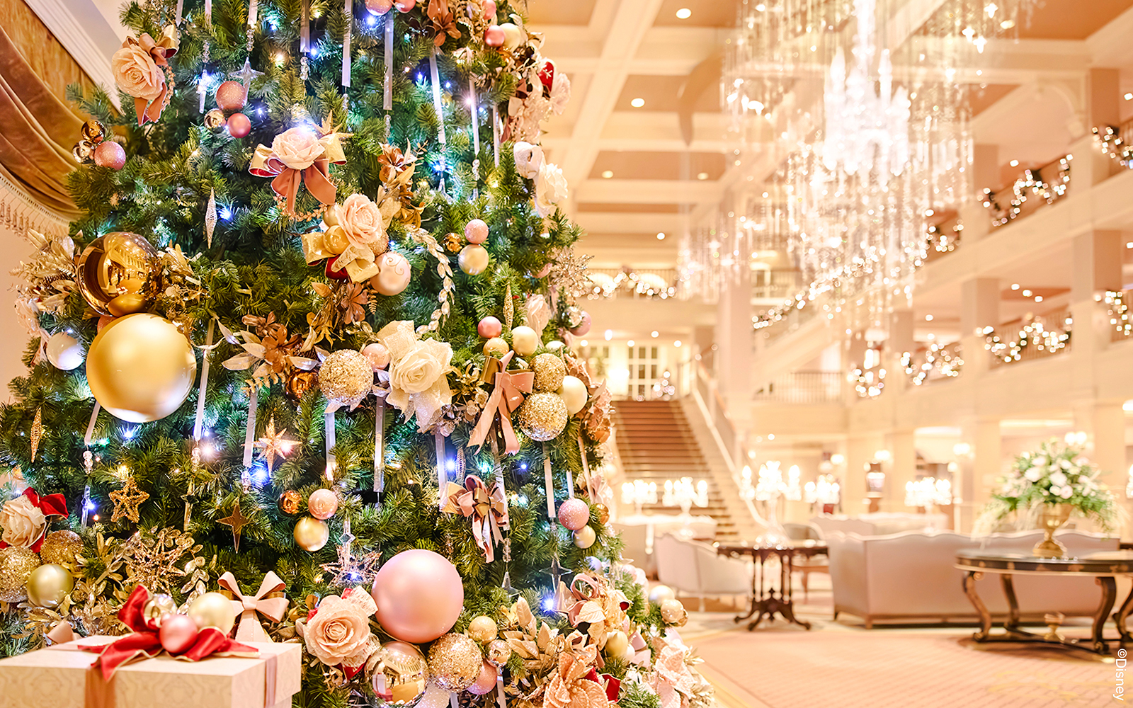 Christmas tree with ornaments and lights in Disneyland Paris hotel lobby, 2025.