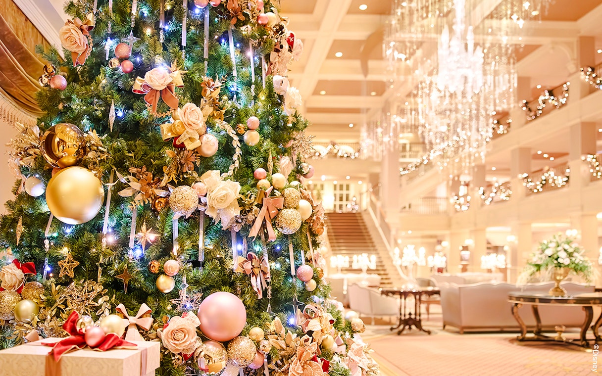 Christmas tree with ornaments and lights in Disneyland Paris hotel lobby, 2025.