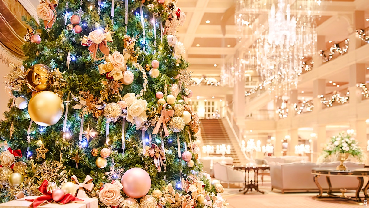 Christmas tree with ornaments and lights in Disneyland Paris hotel lobby, 2025.