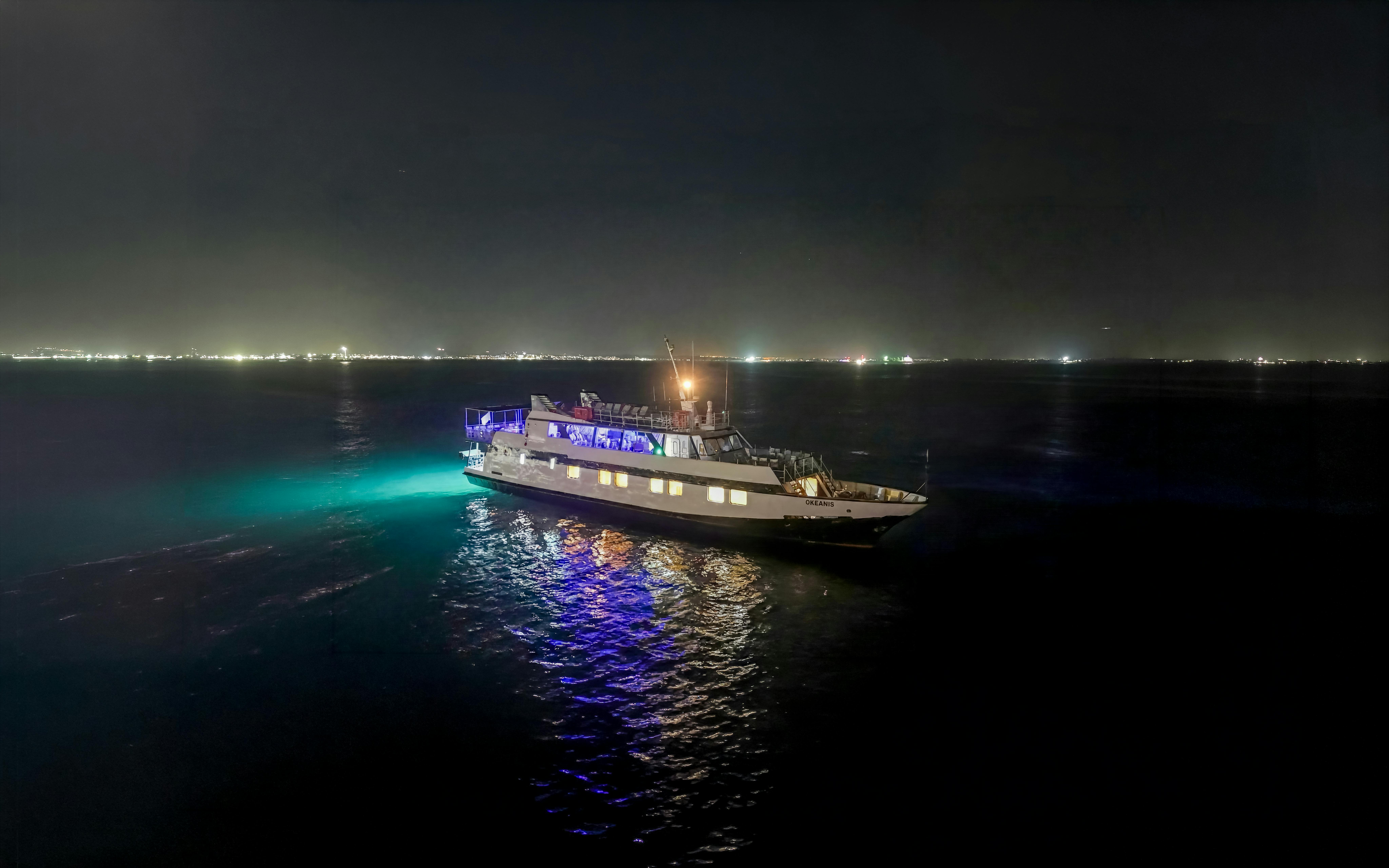 Cruise ship illuminated at night on Larnaca's waters during disco sunset tour.