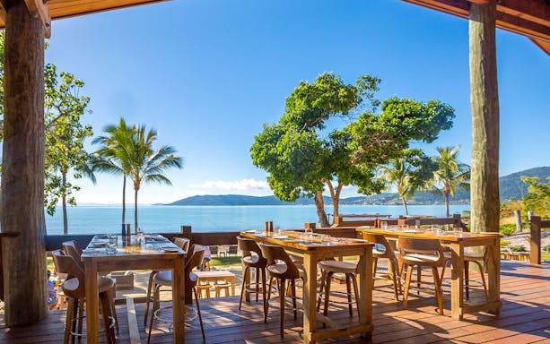 Outdoor dining area overlooking ocean and mountains on Falls to Paradise Guided Day Tour.