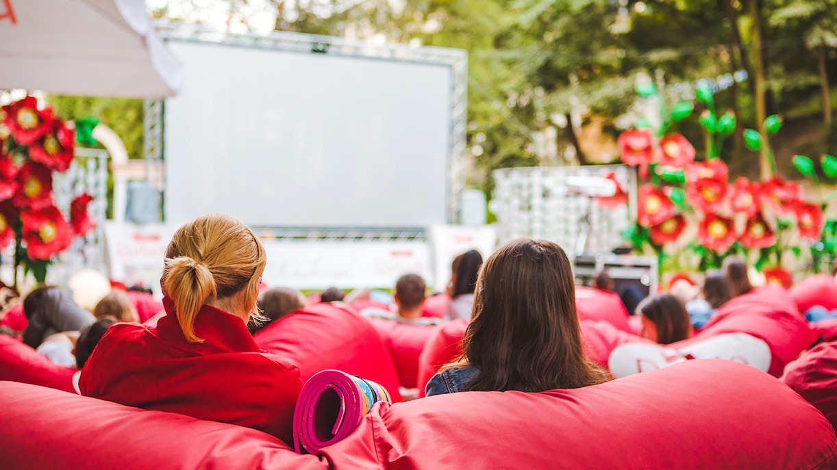 Open-air cinema at Parc de la Villette, Paris, with audience on red bean bags.