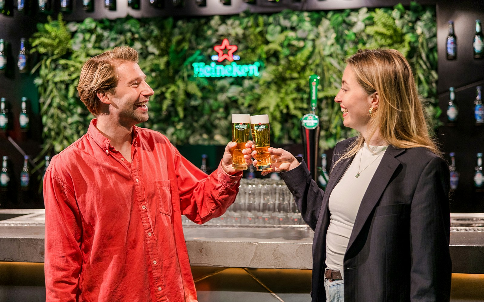 Tourists engaging with interactive displays at Heineken Experience, Amsterdam.