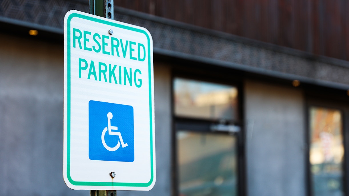 Handicap parking sign in a designated blue badge area.