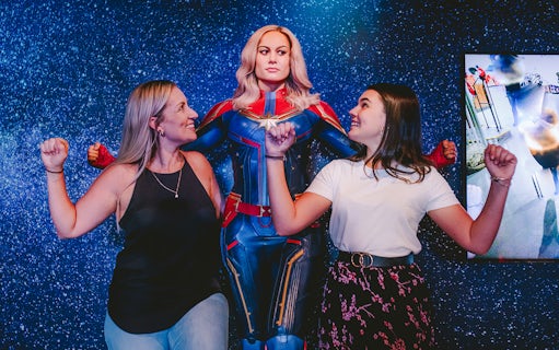 Guests posing with Captain Marvel figure at Madame Tussauds Sydney.