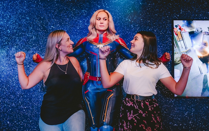 Guests posing with Captain Marvel figure at Madame Tussauds Sydney.