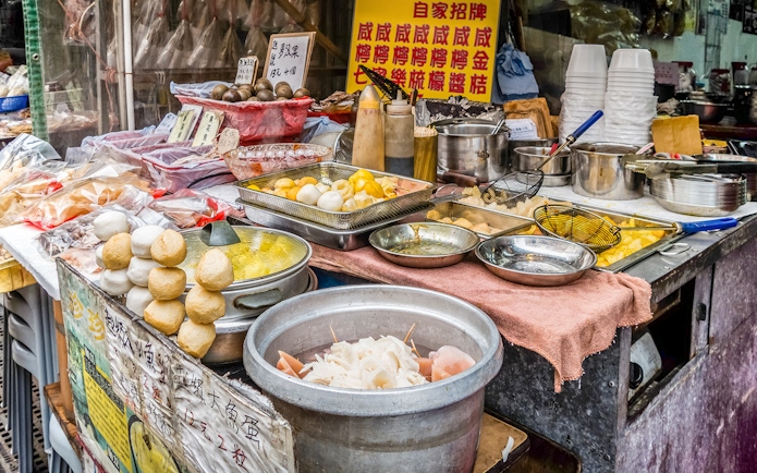 Street food stall with traditional snacks on Lantau Island during Ngong Ping Cable Car Ride tour.