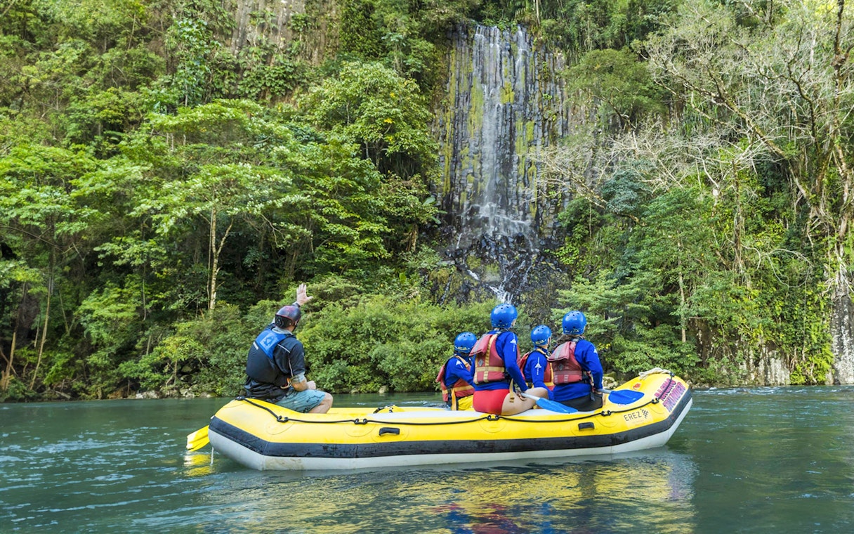 Rafting group on Barron River near waterfall, Raging Thunder experience.