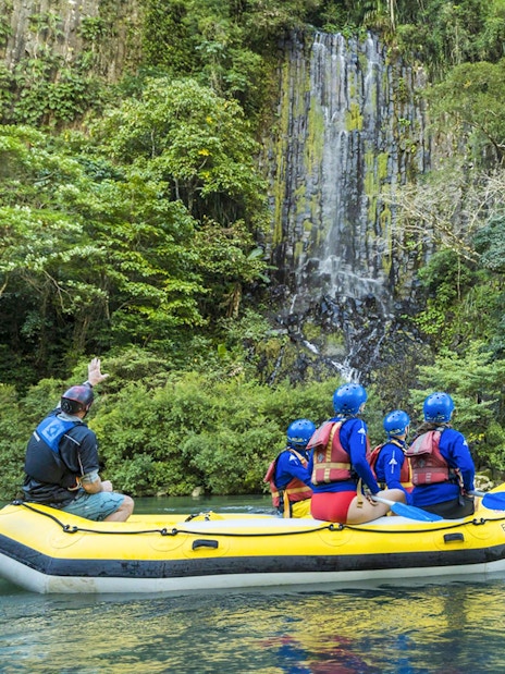Rafting group on Barron River near waterfall, Raging Thunder experience.