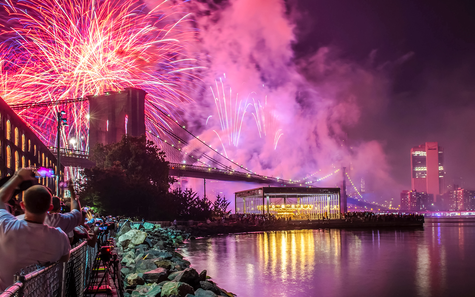 Fireworks display over Brooklyn Bridge at night, New York City.