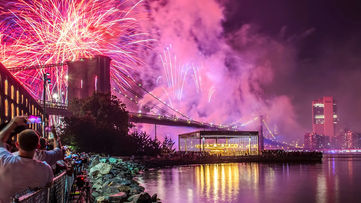 Fireworks display over Brooklyn Bridge at night, New York City.