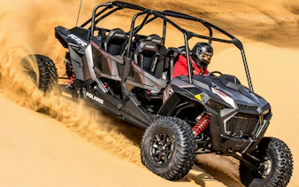 Desert buggy navigating sand dunes on a 4-seater safari adventure.