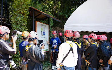 Safety briefing at Hanuman World with group wearing helmets and harnesses.