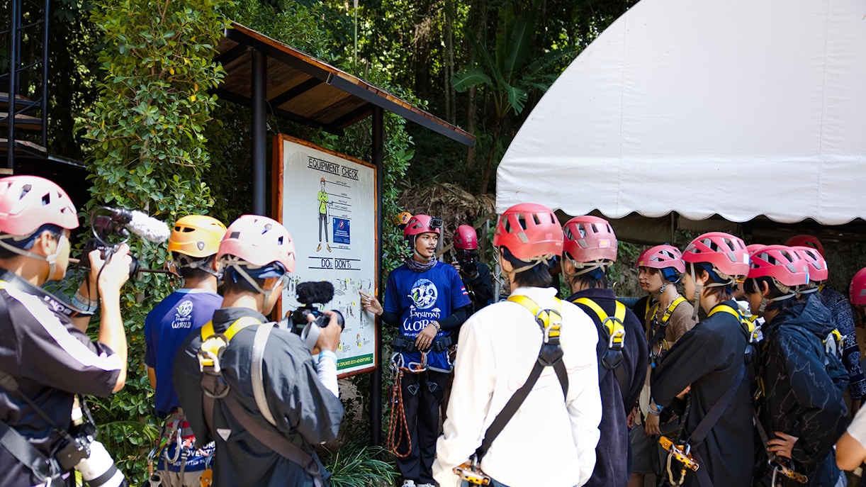 Safety briefing at Hanuman World with group wearing helmets and harnesses.