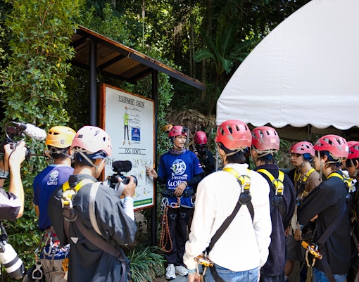 Safety briefing at Hanuman World with group wearing helmets and harnesses.
