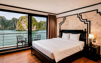 Du Junior Cabin with sea view on Ha Long Bay 5-Star Premium Cruise, featuring elegant decor and balcony.
