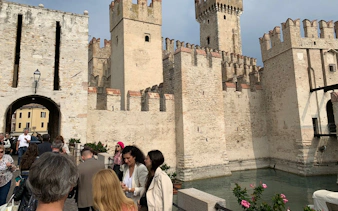Sirmione Castle with tourists exploring the historic site in Verona, Italy.